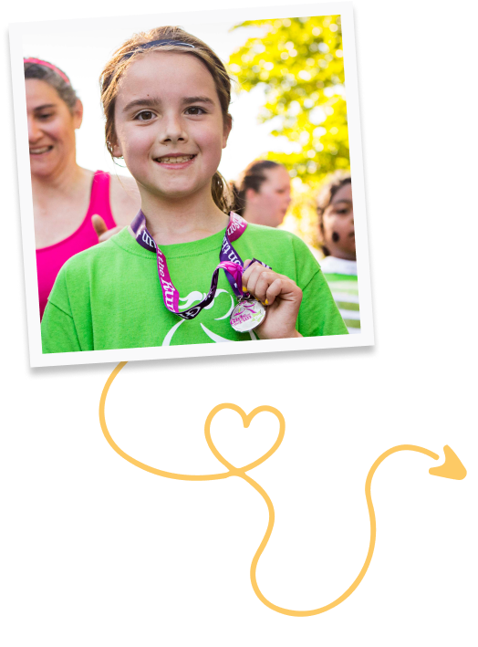 Girls on the Run participants smiling while showing off 5k medal